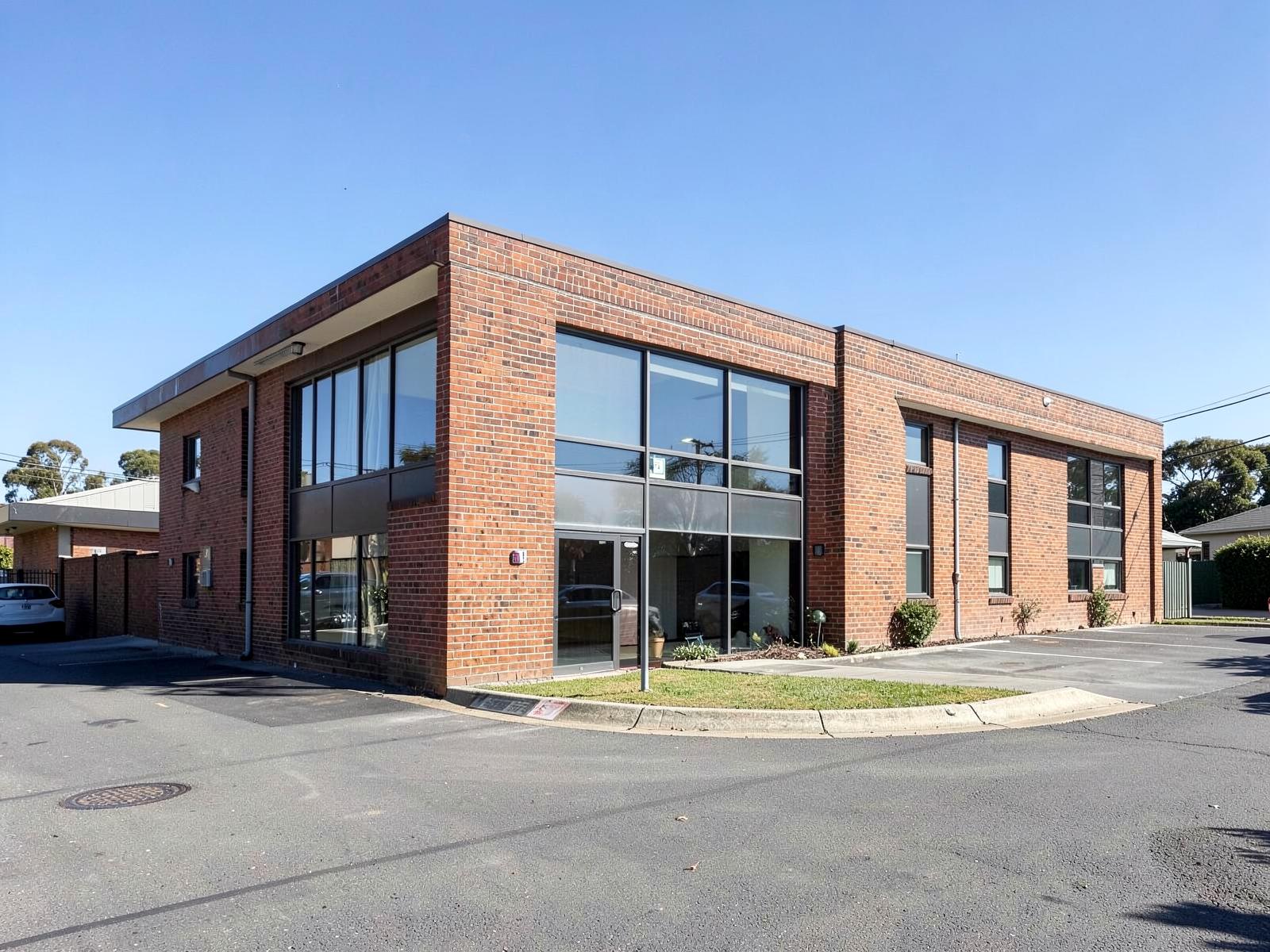 Single tenancy suburban commercial building behind a small car park.