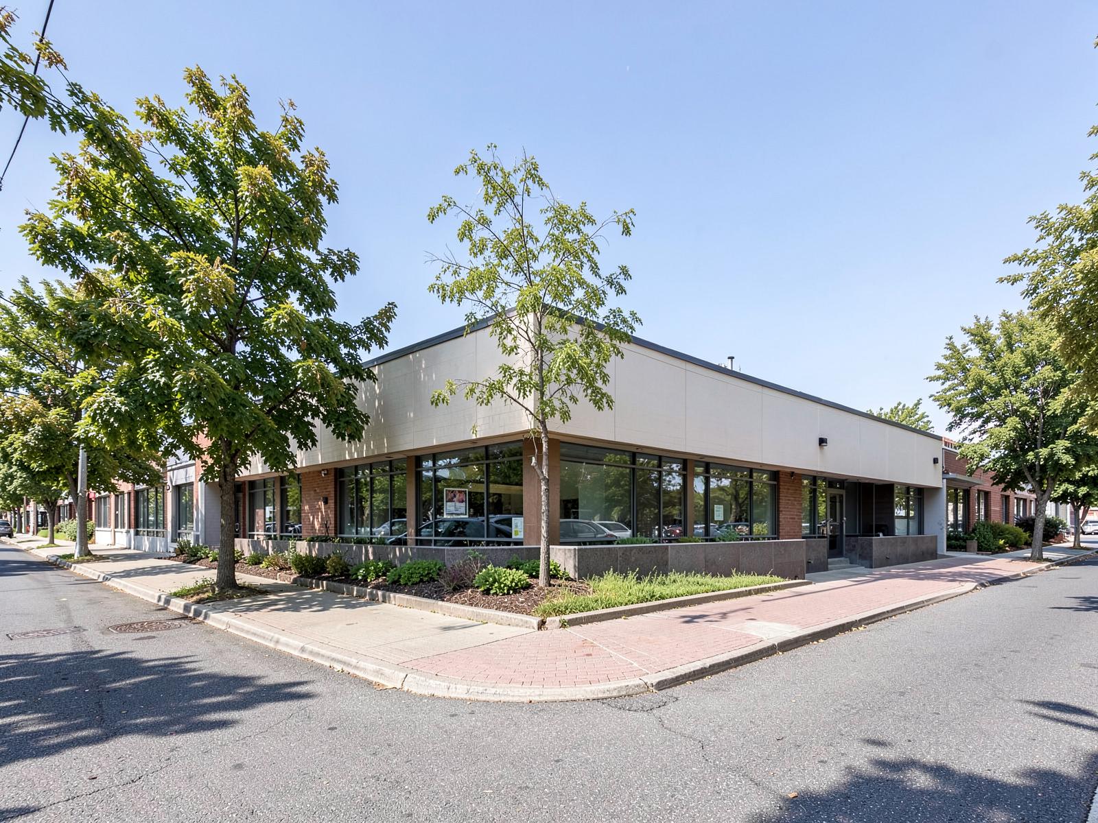 A wide corner site with a low commercial building and deep setback.